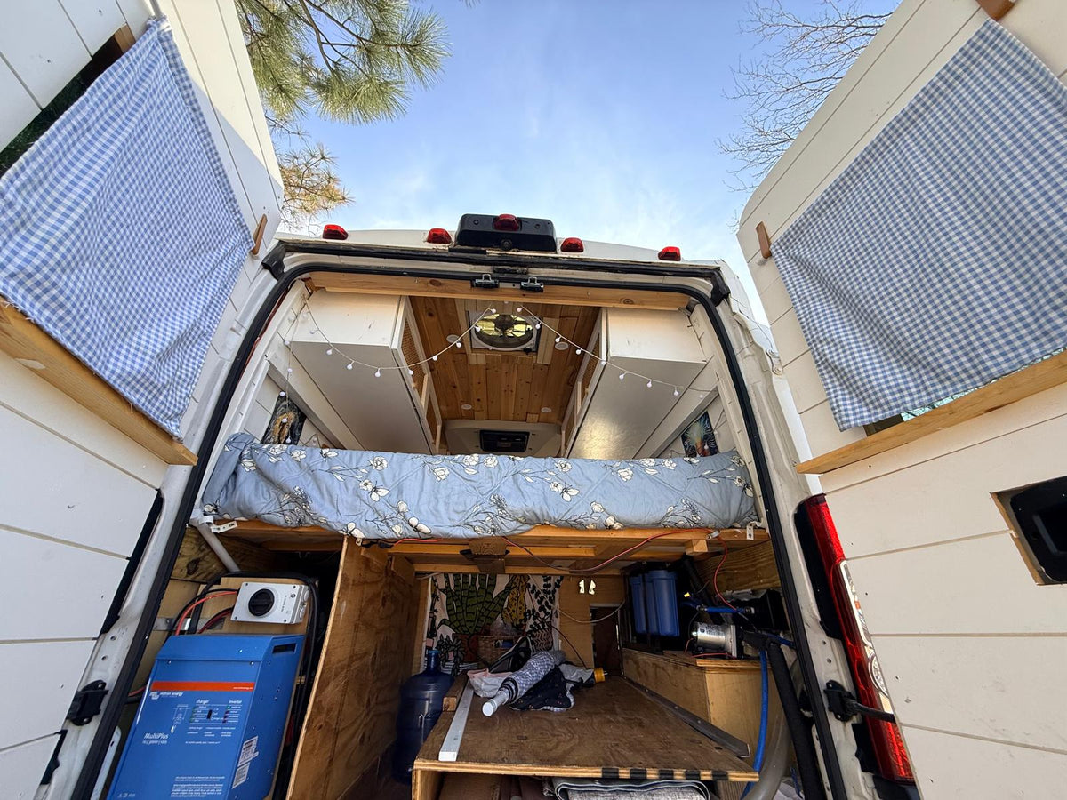  and privacy curtains for the front cabin.|Cozy camper van interior featuring custom overhead cabinets with rattan inserts — photo 7