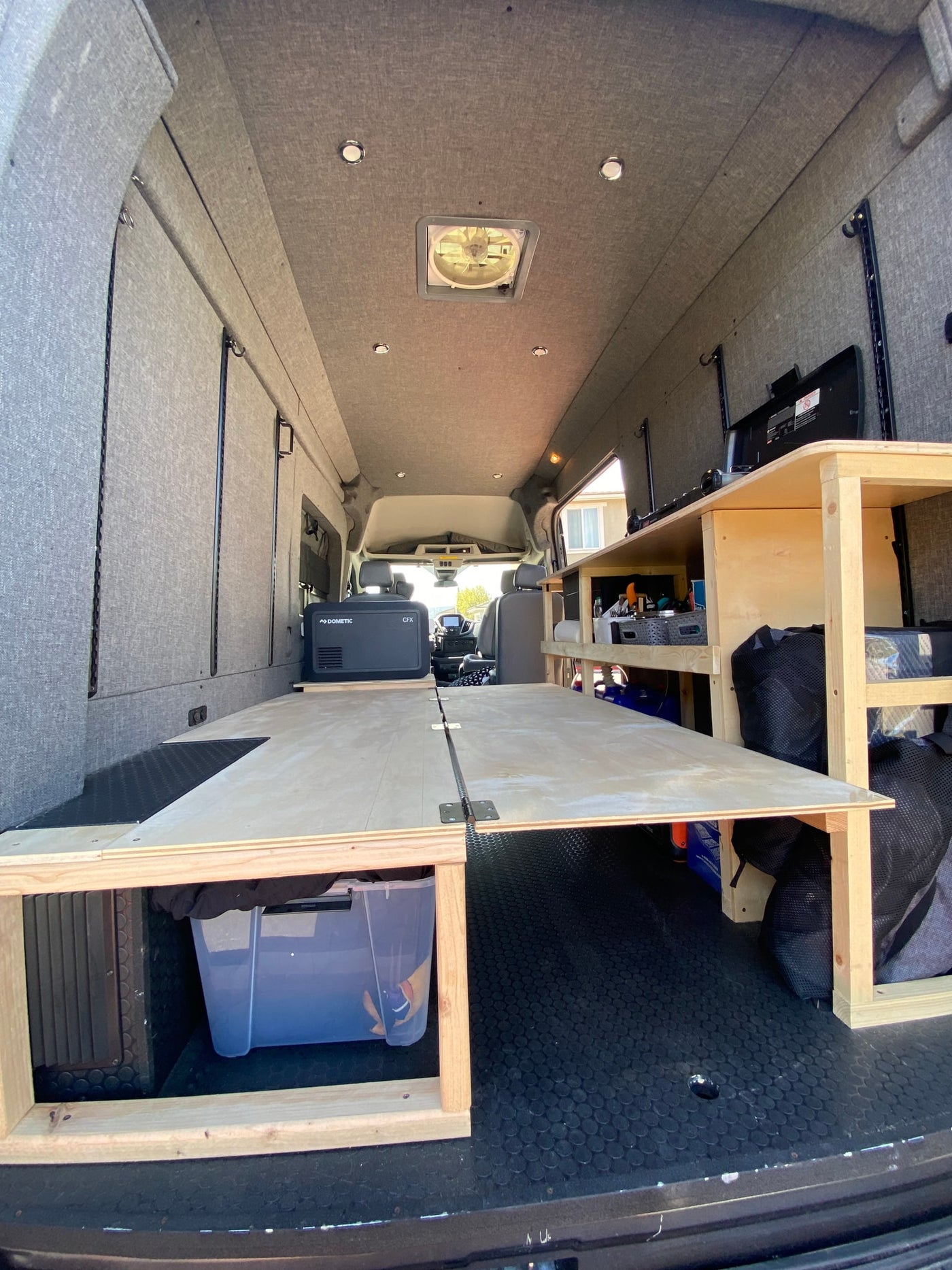 Explore this custom van conversion! Perfect for an **rv rental**, featuring a foldable bed, Dometic fridge, and ample storage. — photo 8