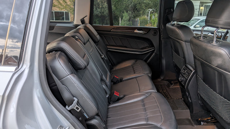 Spacious rear leather seats in this rental SUV, perfect for your next RV rental alternative trip. — photo 10
