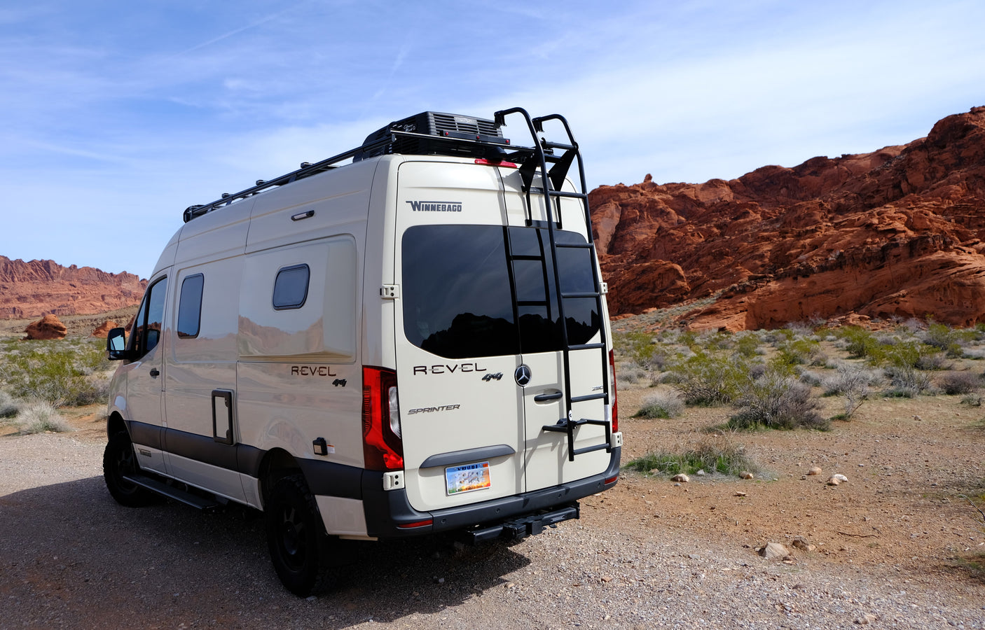 Winnebago Revel 4x4 Sprinter camper van, a perfect rv rental for desert adventures among red rock formations.