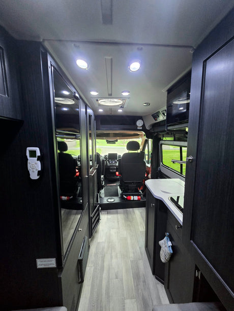  custom camper van with knobby tires and an awning