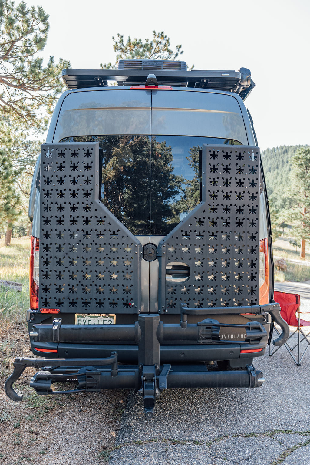  parked in a forest. Perfect for an RV rental outdoor adventure.|Storyteller camper van with open door — photo 3
