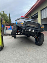 Rugged off-road truck on a forklift, demonstrating extreme suspension articulation. Great for demanding rv rental adventures.
