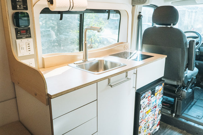 and a view of a white SUV outside.|Two happy dogs relax in a cozy RV rental — photo 3