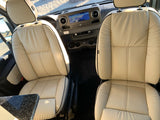 Explore comfort in this RV rental! View the front cabin with plush seats, navigation, and dashboard from a traveler's perspective.