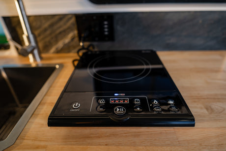 This RV rental kitchen features a portable induction cooktop with digital controls for cooking modes like boil & hot pot.