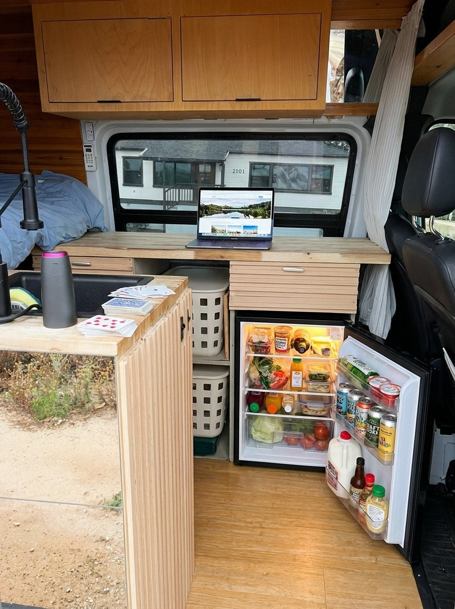  parked under palm trees against a blue sky.|Cozy rv rental interior: laptop workspace on a wooden desk — photo 2