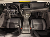 Overhead view of a modern Ford van interior, ideal for rv rental. Features dashboard, steering wheel, shifter, and two black leather seats.