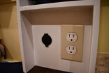 RV rental interior features convenient power options: a standard AC duplex outlet and a round black DC port.