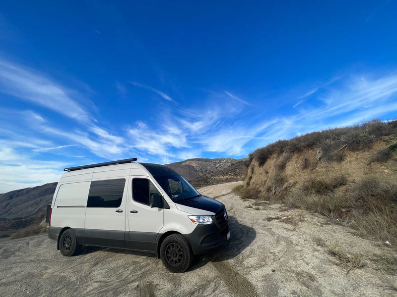  and space for surfboards.|Golden hour camping scene with a modern RV rental camper van parked under trees — photo 6