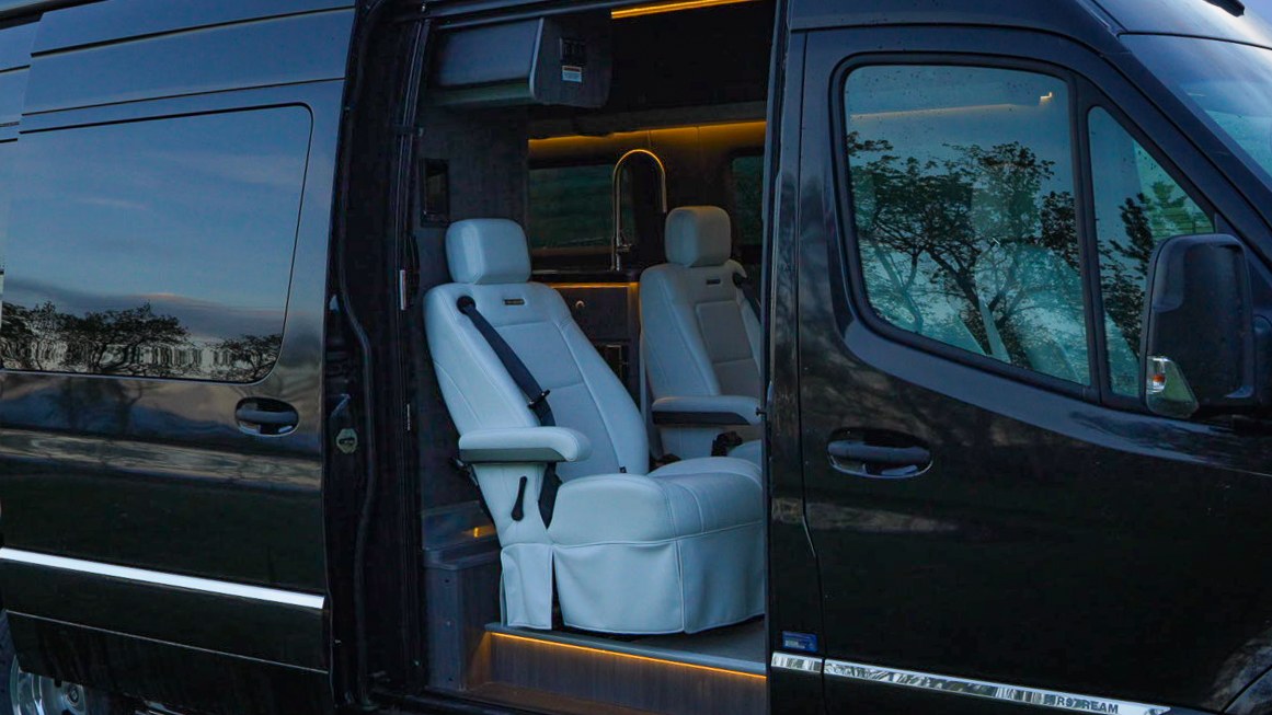  is parked on grass. Your next adventure awaits!|This RV rental is parked in a scenic spot at dusk