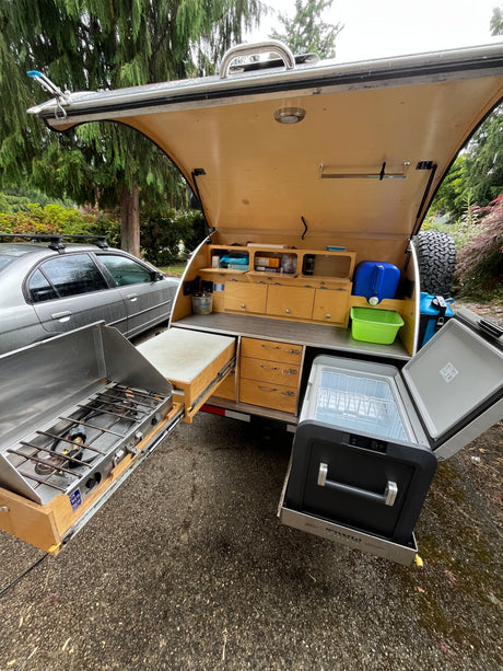 This rv rental offers a compact camper with an open rear kitchen: slide-out stove, fridge, and storage for outdoor trips.