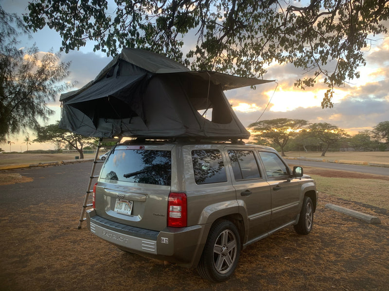 RV rental: Tan Jeep Patriot with rooftop tent, set up for camping at sunset. Perfect for adventure travel! — photo 2