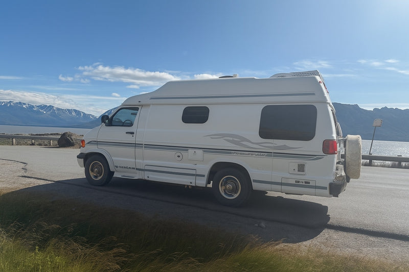 White RV parked by a scenic lake and mountains. An ideal rv rental for exploring beautiful landscapes. — photo 10