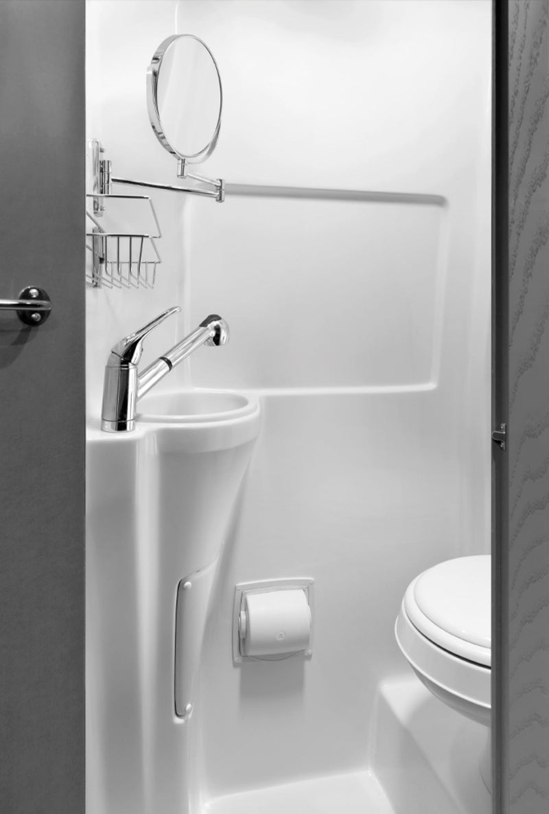 This compact RV rental bathroom features a white sink, pull-out faucet/shower, extendable mirror, and toilet. Optimized for travel. — photo 9