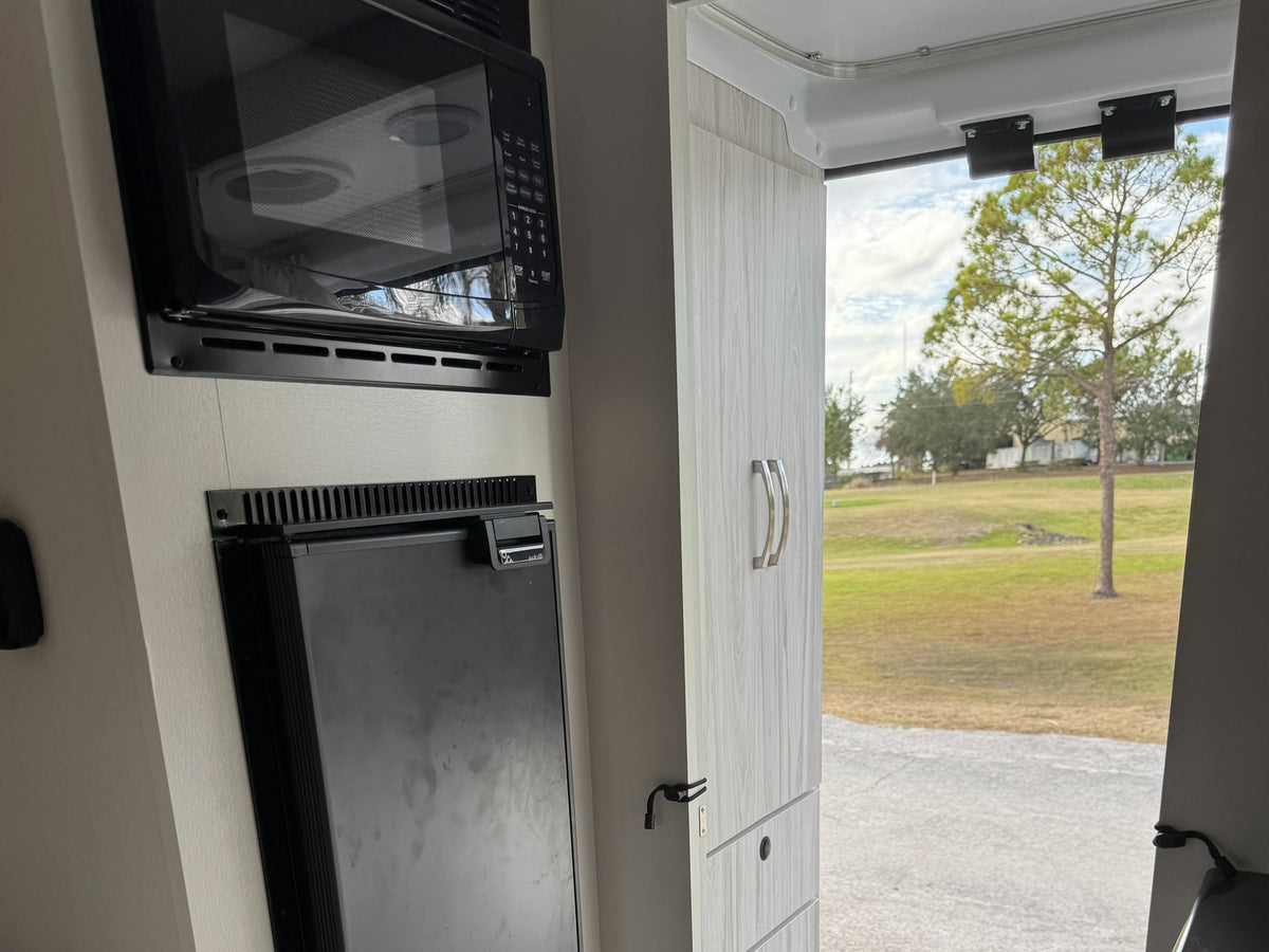  and comfortable seating leading to the cockpit.|RV rental interior featuring a kitchenette — photo 18