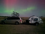 An RV rental, minivan & bikes beneath the stunning Northern Lights. An unforgettable camping experience!