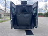 RV rental: Rear view with doors open, showing a black privacy enclosure, mesh screen, and ground mat for outdoor use.