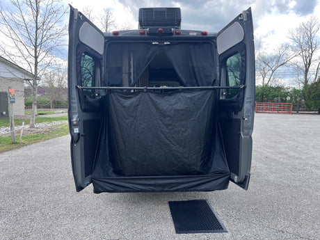 RV rental: Rear view with doors open, showing a black privacy enclosure, mesh screen, and ground mat for outdoor use.