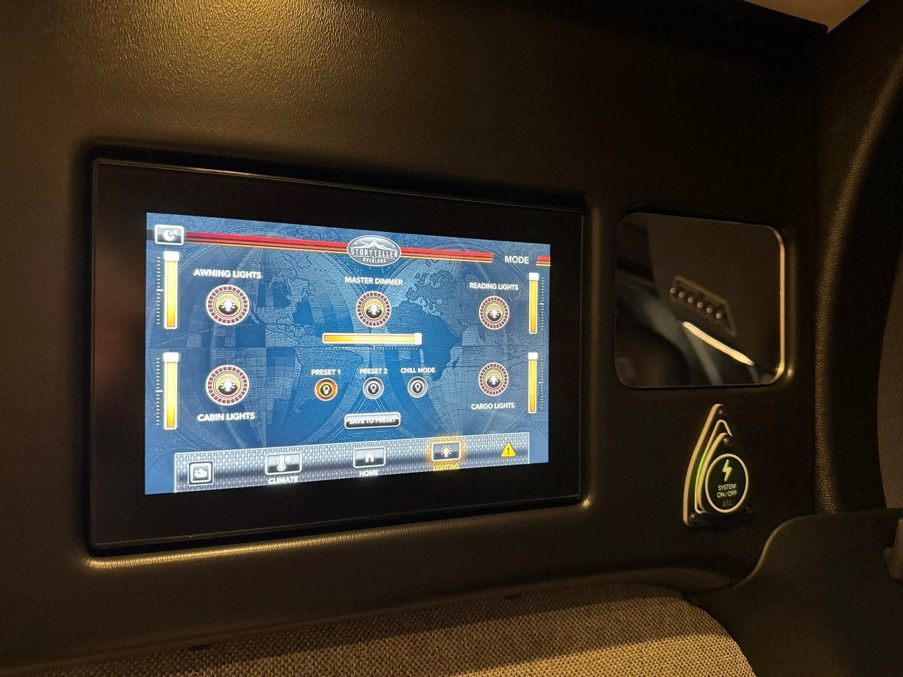 RV rental: Digital panel with lighting controls for various lights. Features dimmer, presets, and System On/Off button.