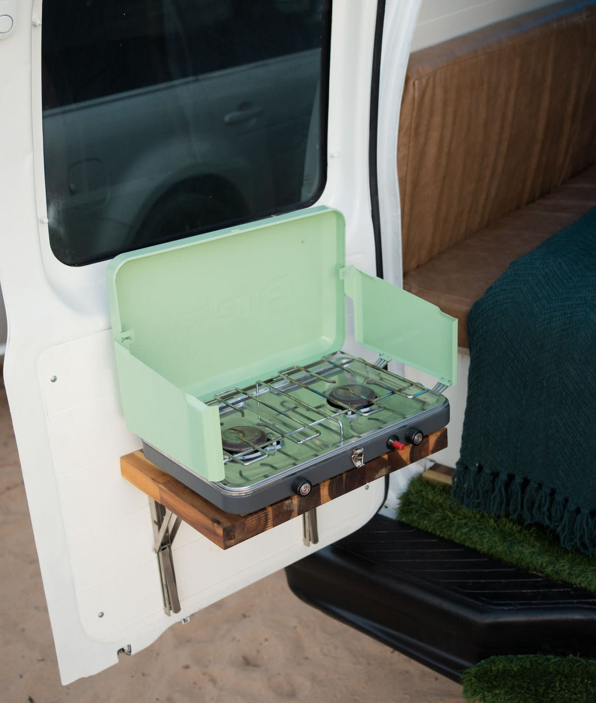  and turf entry.|RV rental: Sleek camper van kitchen. White cabinets — photo 9