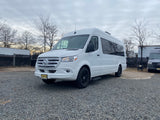 A clean white Mercedes-Benz Sprinter van on gravel. Great for RV rental & road trips in New Jersey.