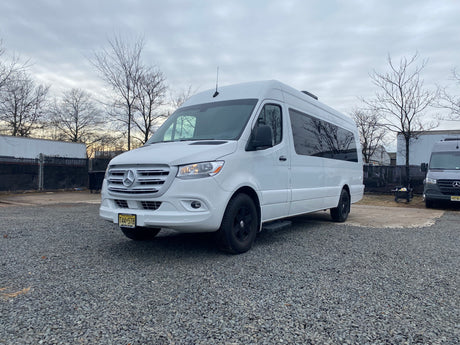 A clean white Mercedes-Benz Sprinter van on gravel. Great for RV rental & road trips in New Jersey.