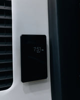 RV rental vehicle interior featuring a digital control panel displaying 7:51 PM Wed, April 9, on a light wall.