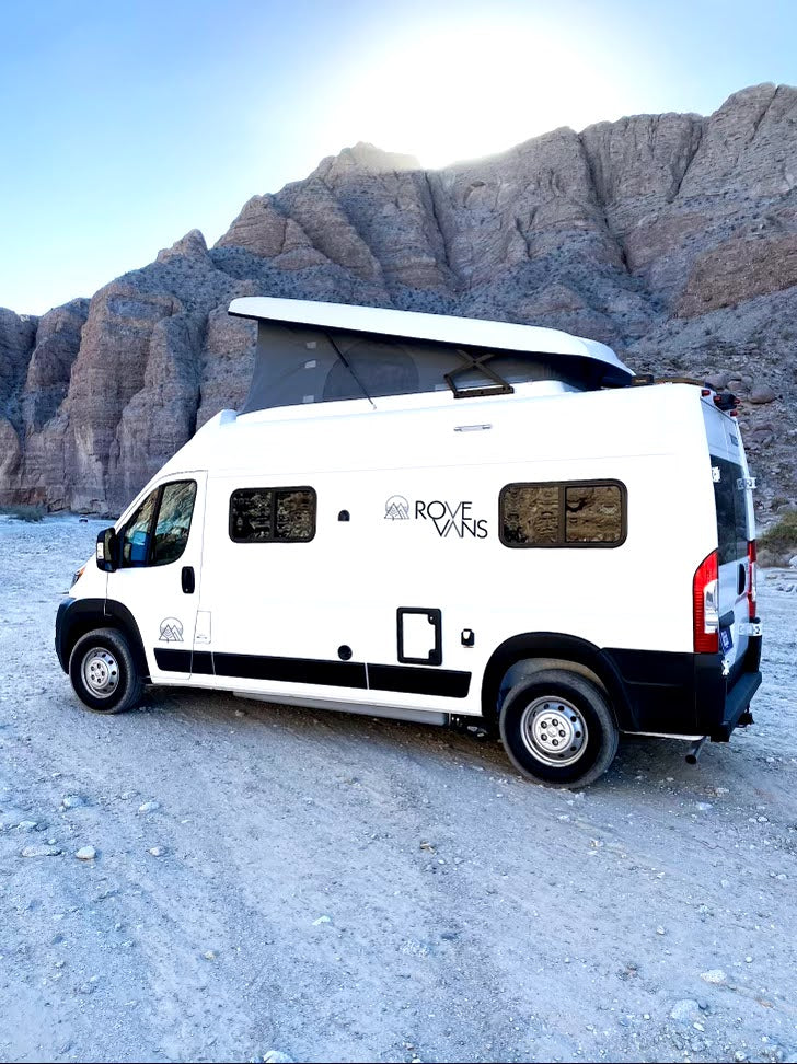 White Rove Vans camper van with a pop-top roof, parked in a sunny mountain desert, ideal for RV rental. — photo 14