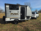 A white SUV tows a Puma Camping Edition RV, perfect for your next rv rental adventure.
