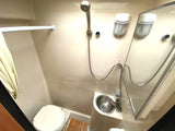 Compact RV rental wet bath, showing shower, sink, toilet, and mirror, designed for efficient travel.