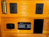 RV rental interior panel with Renogy power control, USB port, AC outlet, and rotary light dimmers.
