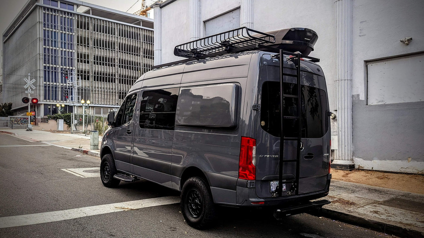  and a roof rack for travel.|RV rental van interior: organized bunk beds — photo 18