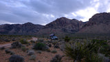 Explore nature with an RV rental: a truck with a rooftop tent ready for mountain camping in the desert.