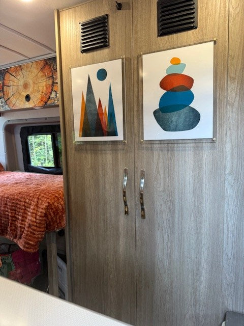  and propane stove top with tea kettle.|A white Winnebago Solis camper van — photo 8