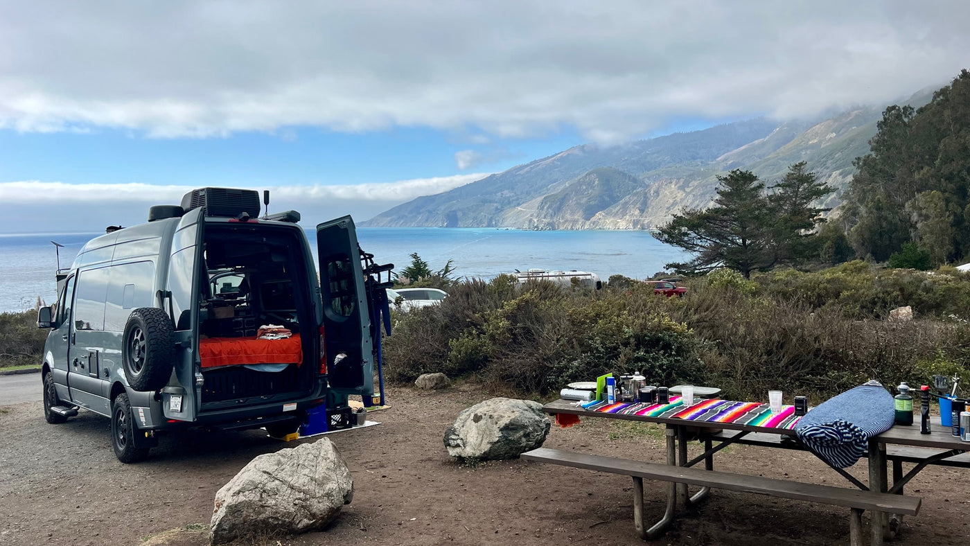  fully set up for a serene camping adventure.|Night shot: A grey RV rental camper van parked outdoors — photo 9