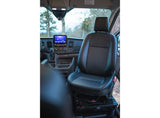The clean interior of an RV rental, showing the black passenger seat, dashboard, and central infotainment screen clearly.
