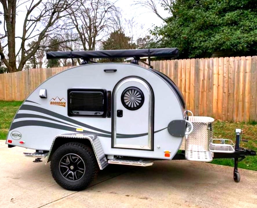 A light gray nuCamp T@G Boondock teardrop rv rental, ready for off-grid camping adventures.