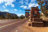 Zion National Park entrance sign & red road. Start your RV rental journey to explore stunning landscapes.
