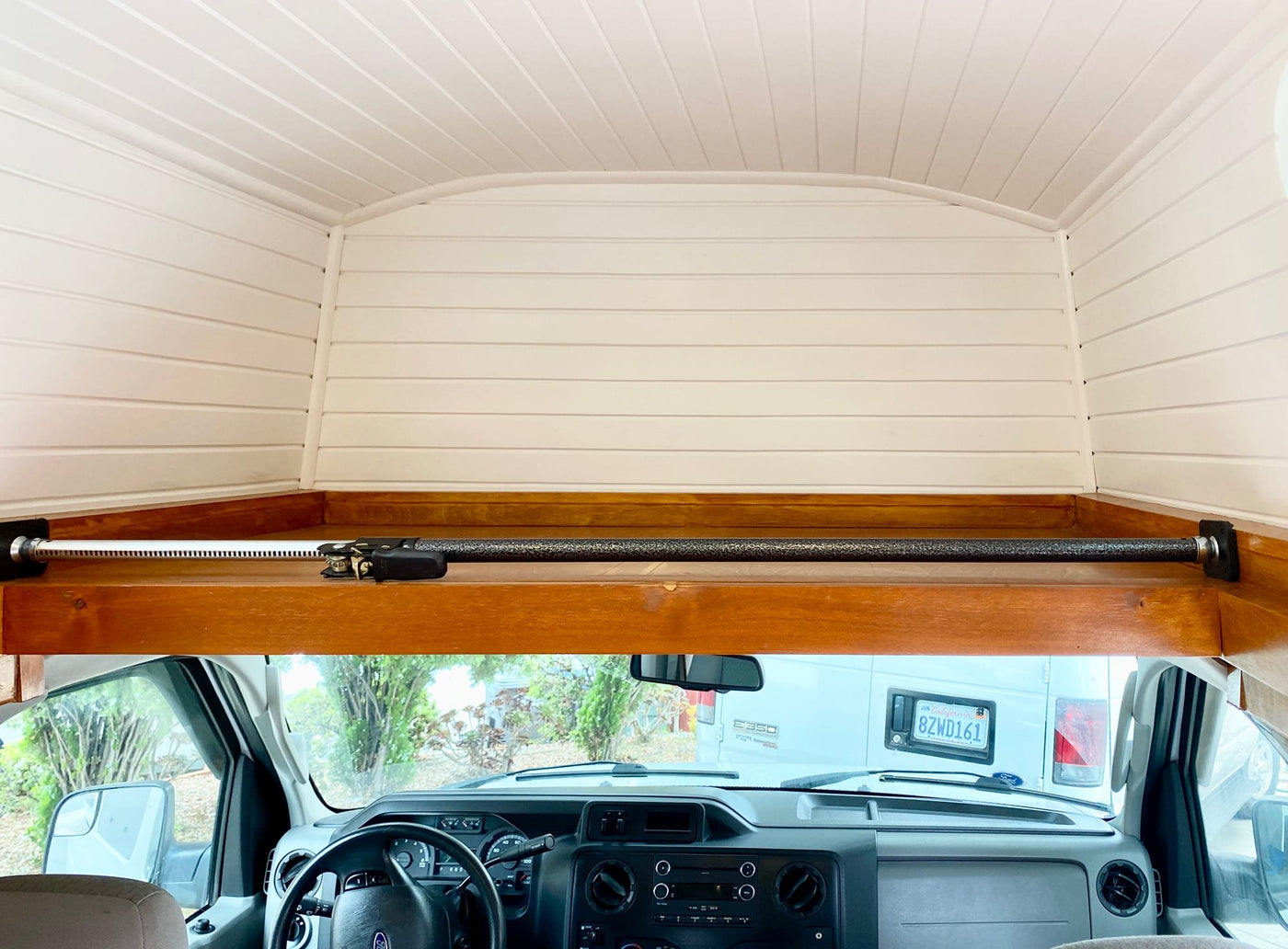  and a silver Lagun table base.|RV rental storage: Hand lifts top flap revealing organized kitchenware – pots — photo 13