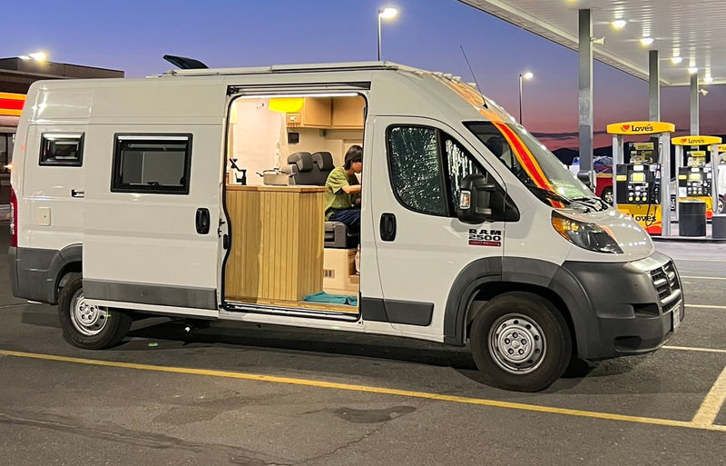  parked on a driveway.|This converted Ram ProMaster camper van — photo 2