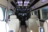 Premium RV rental interior with cream leather seats, ambient lighting, and entertainment system for comfortable travel.