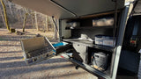 RV rental camp kitchen: pull-out stove, sink, organized storage, and BLUETTI power station for outdoor cooking & adventure.