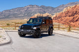 Black Jeep Wrangler in Red Rock Canyon, NV, amidst mountains and vibrant red rocks. Ideal for exploration, enhancing your RV rental journey.
