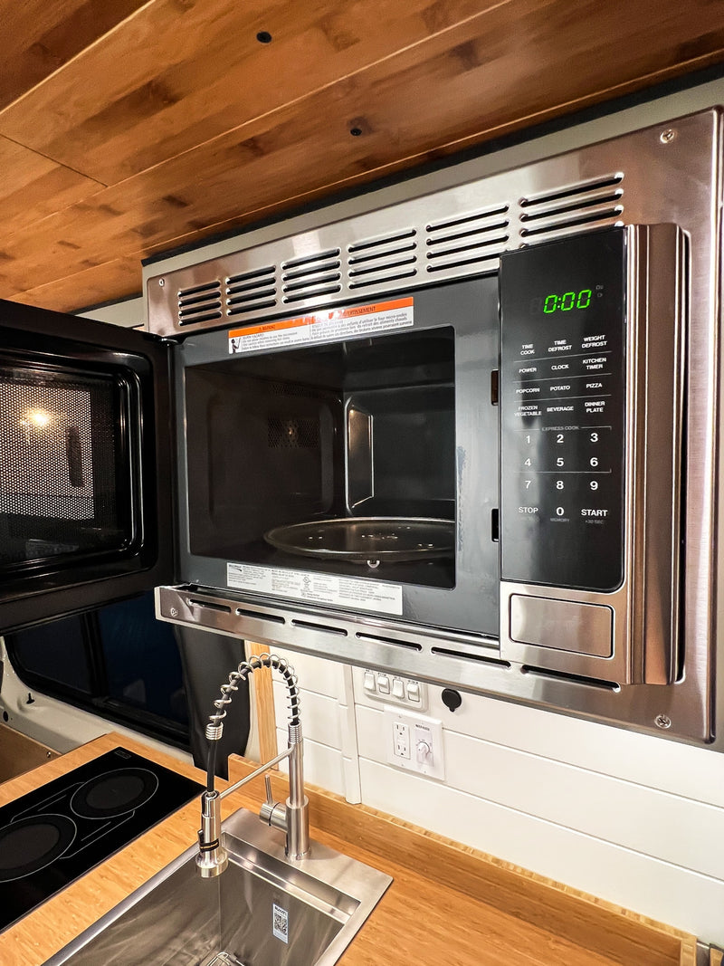  and window with wood paneling & flooring.|Experience a compact **rv rental** interior with a modern shower — photo 7