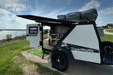 Lakeside rv rental: a Taxa TigerMoth camper with an open side, showing interior and a Thule rooftop tent.