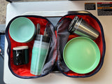 Portable kitchen gear with bowls, plates, and mugs, packed in a case, ready for an RV rental trip, beside safety warnings.