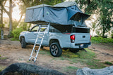 Explore off-grid with this Toyota Tacoma 4x4 truck featuring an open rooftop tent, ladder & bed storage – an ideal RV rental.