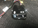 Black Reese trailer brake controller for RV rental, with 'GAIN' and 'SYNC' labels, on dark carpet.