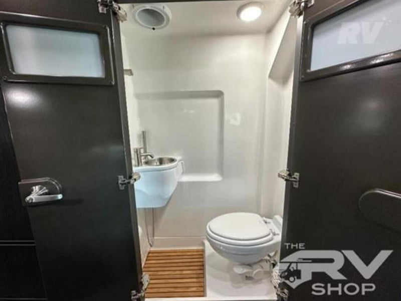  and sleek overhead storage.|Spacious RV rental interior featuring a modern kitchen with microwave & fridge — photo 17